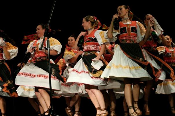 Slovak girls in traditional costume turning around, dancing